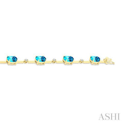 8x6 MM Oval Shape Blue Topaz and 1/4 Ctw Round Cut Diamond Semi-Precious Bracelet in 10K Yellow Gold