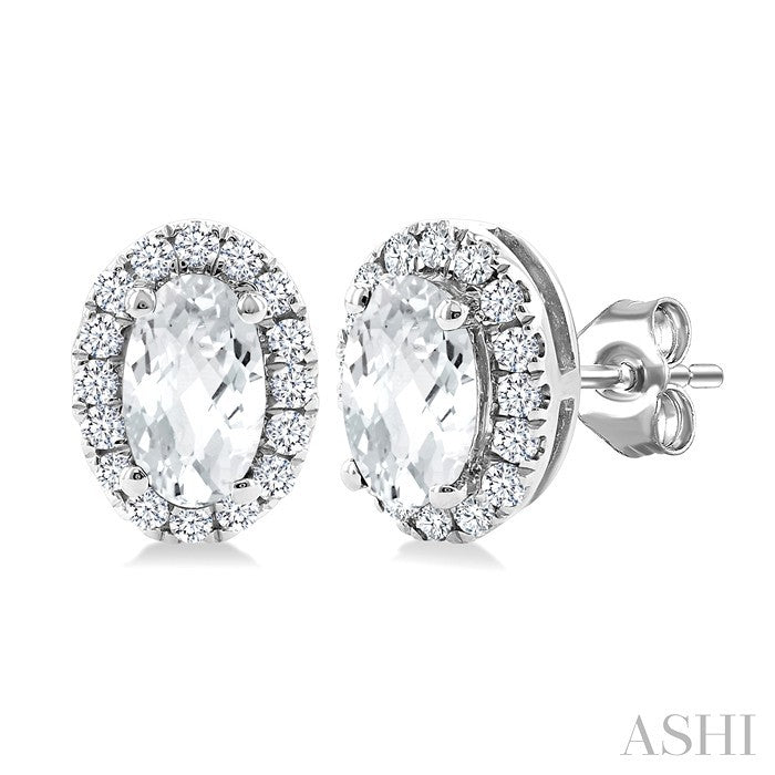 5x3 MM Oval Shape White Topaz and 1/8 Ctw Round Cut Diamond Halo Semi-Precious Stud Earrings in 10K White Gold