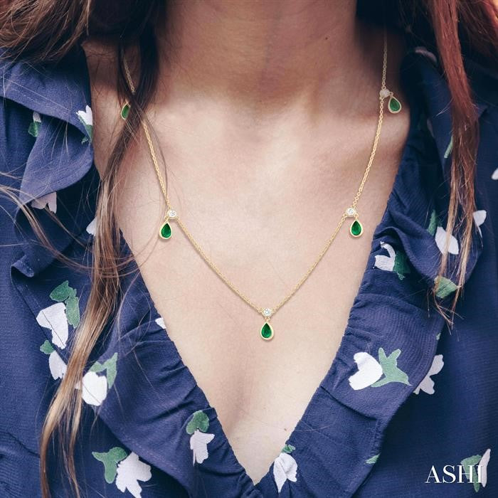 5x3 MM Pear Shape Emerald and 1/8 Ctw Round Cut Diamonds Precious Station Necklace in 10K Yellow Gold